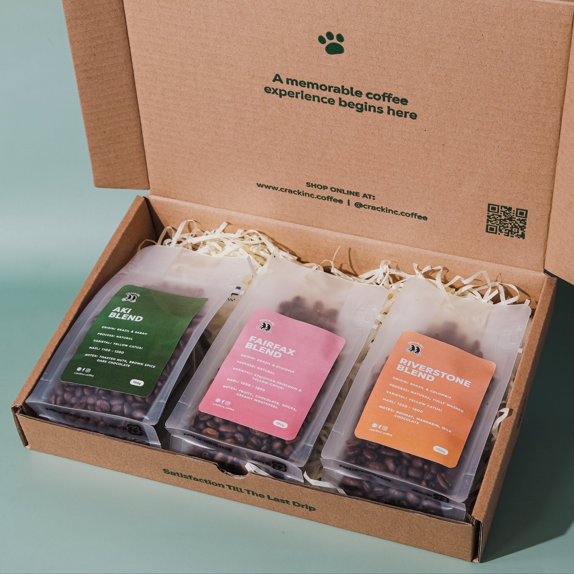 three coffee packages inside a cardbox box with Crack Inc. Branding